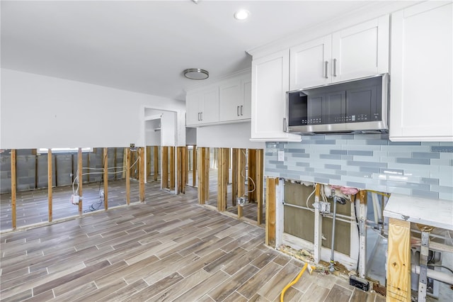 kitchen with light hardwood / wood-style floors and white cabinetry