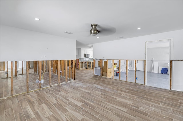 interior space with ceiling fan and light hardwood / wood-style flooring