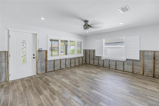 foyer with ceiling fan and light wood-type flooring