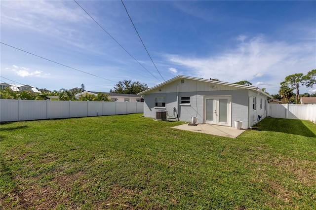 back of house with a lawn, central AC, and a patio area