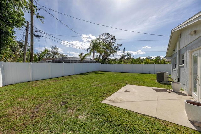 view of yard with central AC unit and a patio area