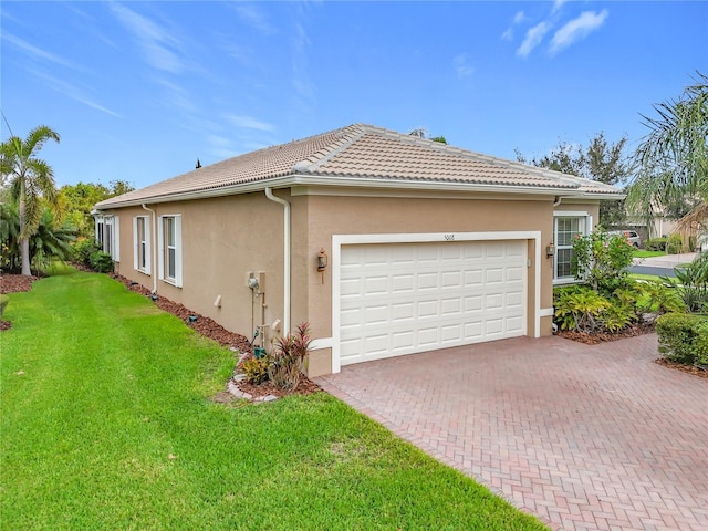 view of side of property featuring a yard and a garage