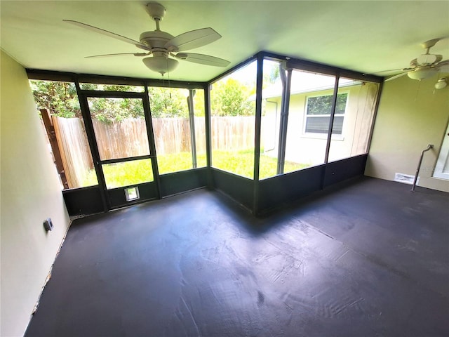 unfurnished sunroom featuring ceiling fan