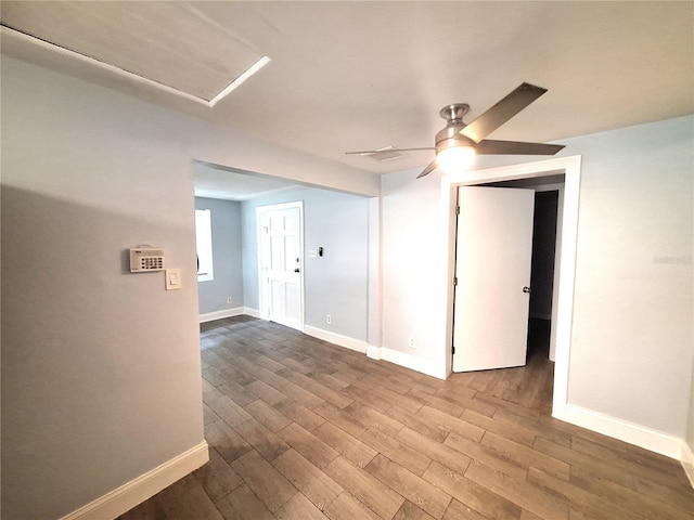 empty room with ceiling fan and hardwood / wood-style flooring