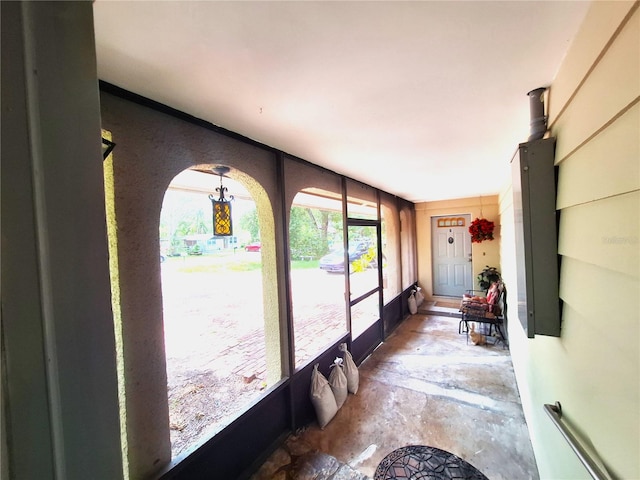 sunroom / solarium featuring an inviting chandelier