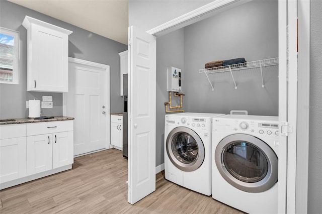 washroom featuring washer and clothes dryer and light hardwood / wood-style flooring