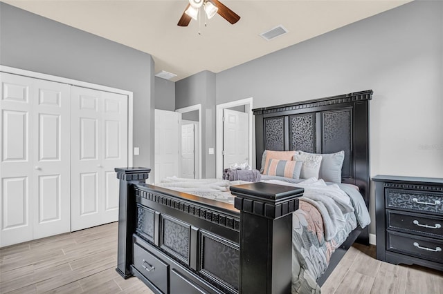 bedroom featuring a closet, light hardwood / wood-style flooring, and ceiling fan