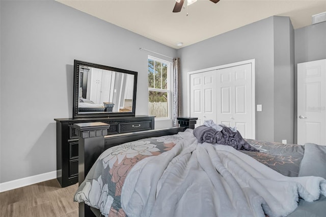 bedroom with a closet, ceiling fan, and hardwood / wood-style flooring