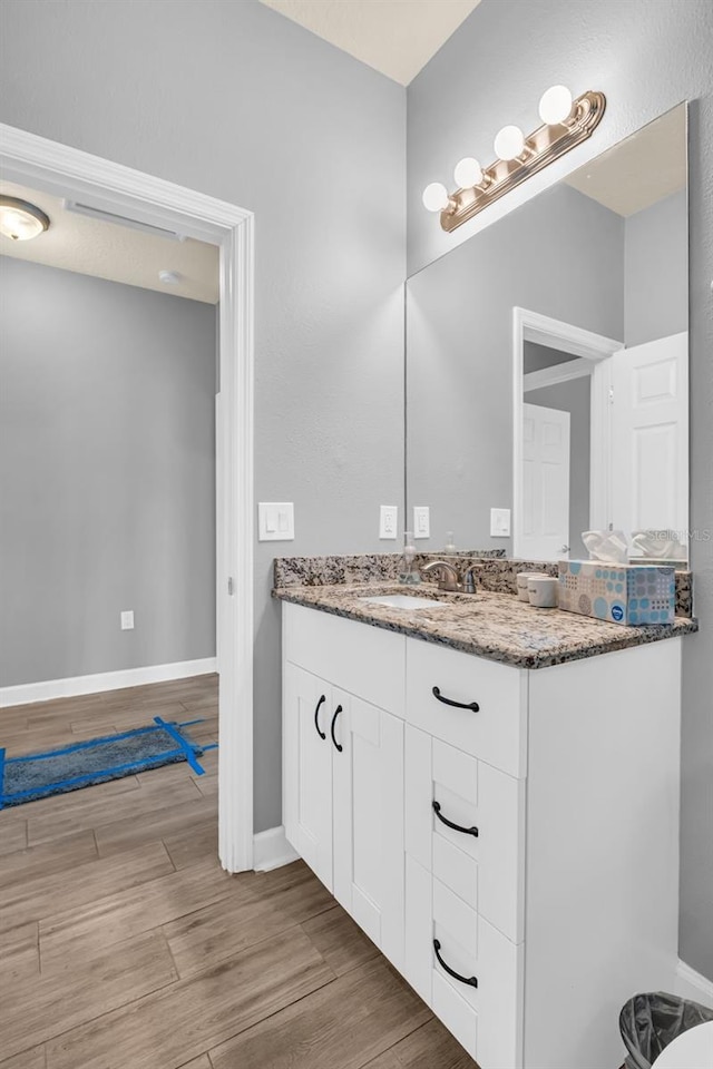 bathroom featuring hardwood / wood-style flooring and vanity