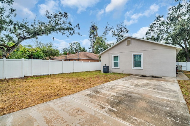 back of property featuring a patio area and central air condition unit