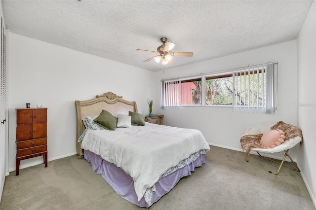 bedroom with a textured ceiling, carpet floors, a ceiling fan, and baseboards