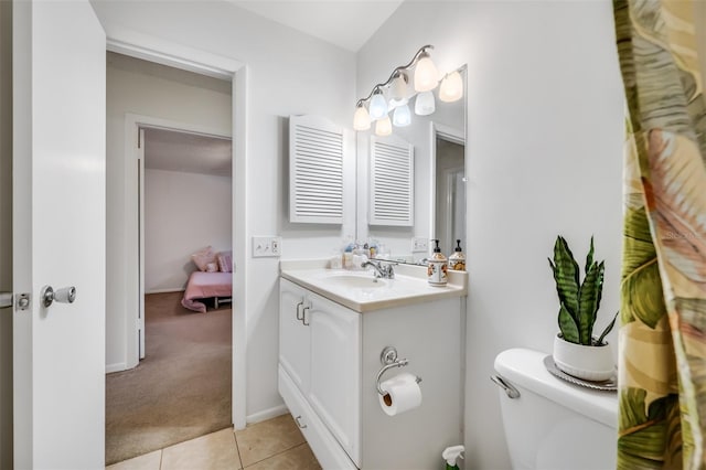 bathroom featuring vanity, toilet, and tile patterned floors