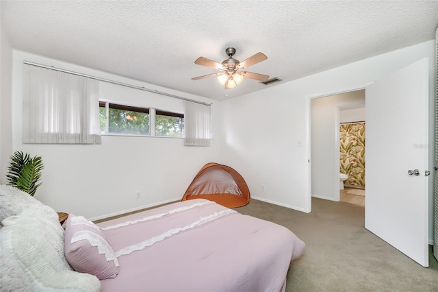 bedroom featuring baseboards, visible vents, a ceiling fan, a textured ceiling, and carpet flooring