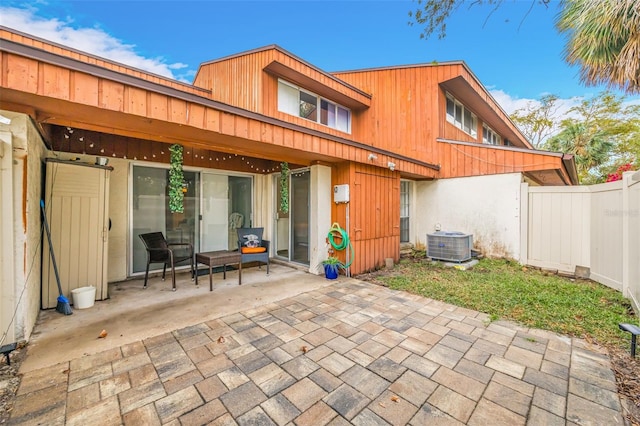 back of property with a patio, central AC unit, and fence