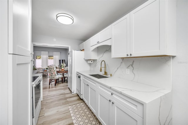 kitchen featuring a sink and white cabinets