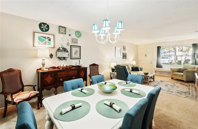 dining area with light carpet and an inviting chandelier