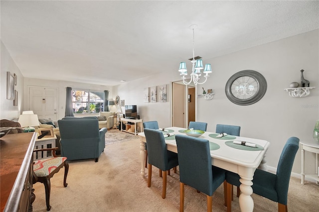 dining space with light colored carpet and a notable chandelier