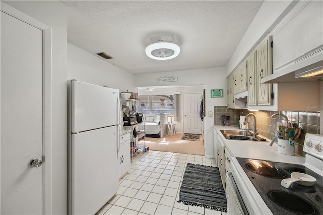 kitchen featuring white cabinets, white appliances, tasteful backsplash, and sink