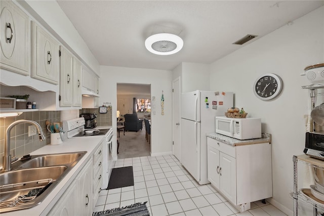 kitchen with white cabinets, decorative backsplash, white appliances, and sink