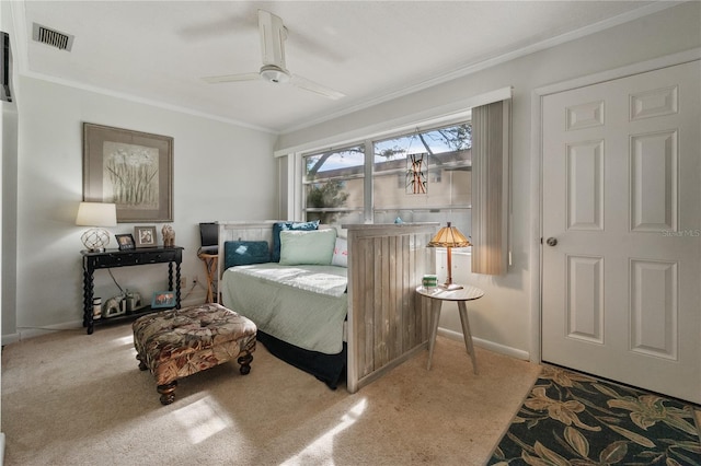 sitting room with carpet floors, ceiling fan, and ornamental molding