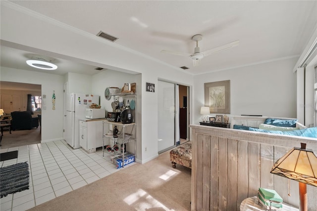 interior space featuring light colored carpet, ceiling fan, and ornamental molding