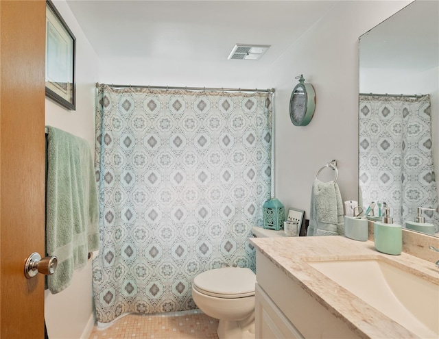 bathroom featuring tile patterned floors, vanity, and toilet