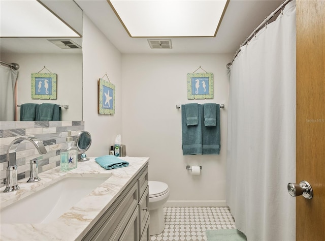 bathroom with tasteful backsplash, vanity, and toilet