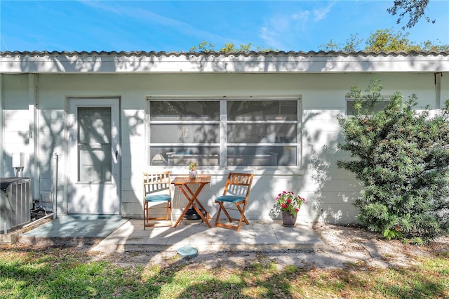 back of property featuring central air condition unit and a patio