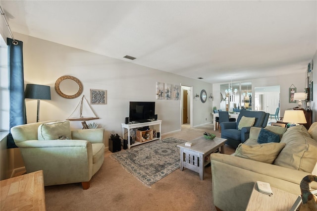 living room featuring an inviting chandelier and light colored carpet