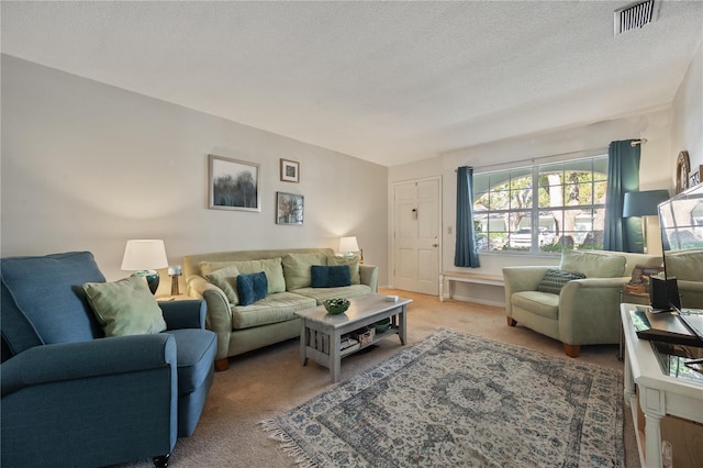carpeted living room featuring a textured ceiling