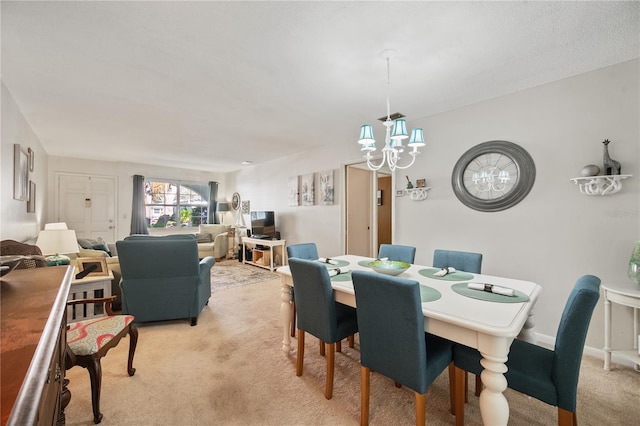 dining space featuring light colored carpet and a notable chandelier