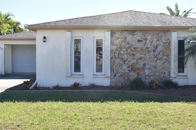 view of side of home featuring a lawn and a garage