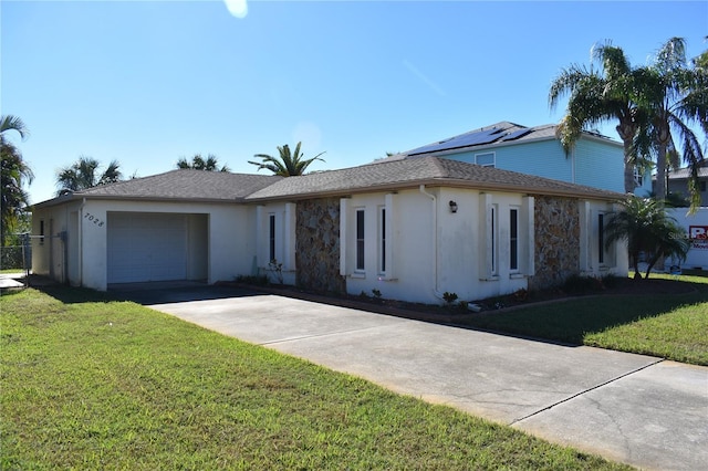 ranch-style home with a garage and a front lawn