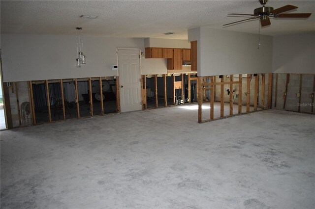 interior space featuring ceiling fan and a textured ceiling