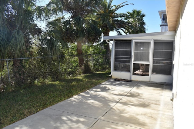 view of patio with a sunroom