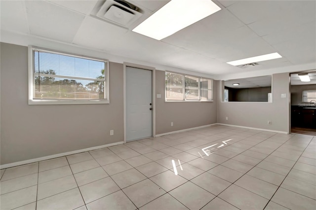 basement featuring light tile patterned flooring