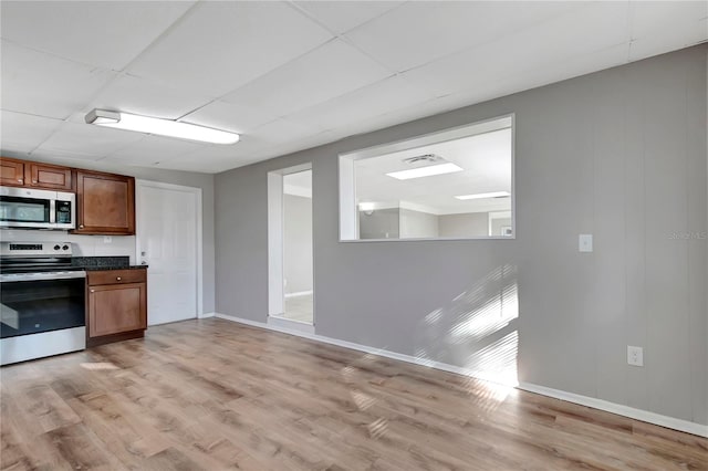 kitchen featuring appliances with stainless steel finishes and light hardwood / wood-style flooring