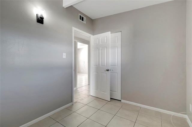 interior space with a closet and light tile patterned floors