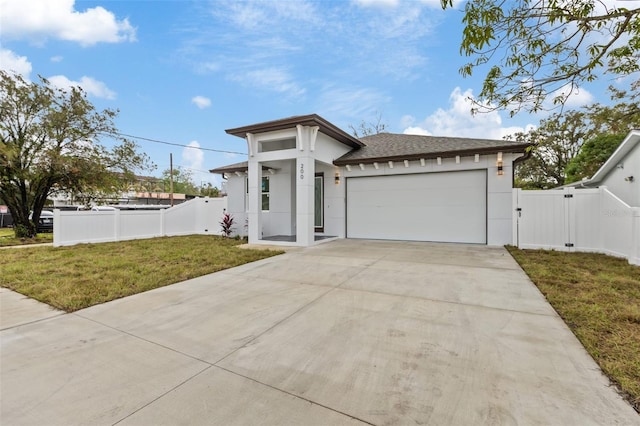 view of front of house with a garage and a front lawn