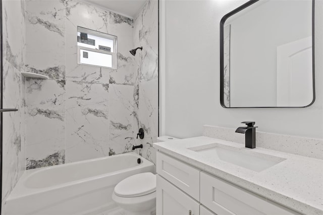 full bathroom with toilet, vanity, and tiled shower / bath