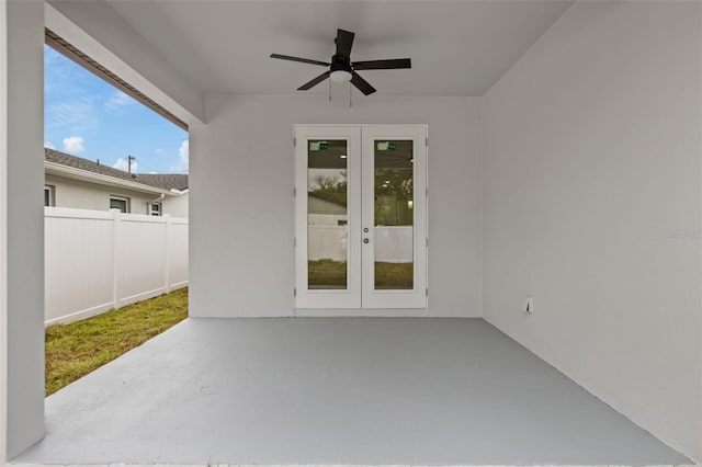 entrance to property featuring ceiling fan, french doors, and a patio