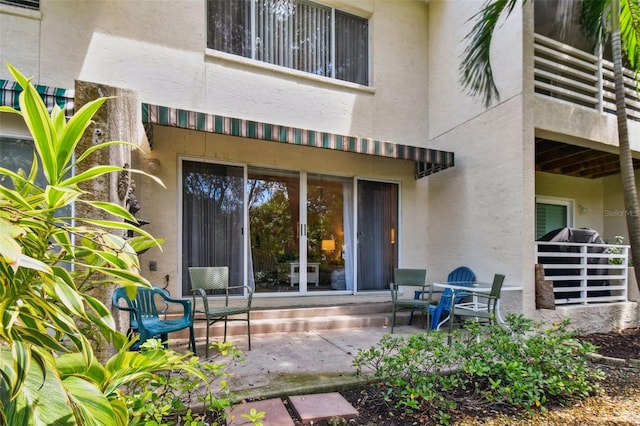 property entrance featuring a patio area