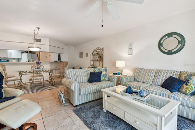 tiled living room featuring ceiling fan