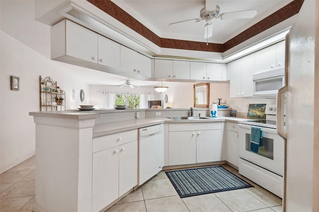 kitchen featuring kitchen peninsula, white appliances, white cabinets, and sink