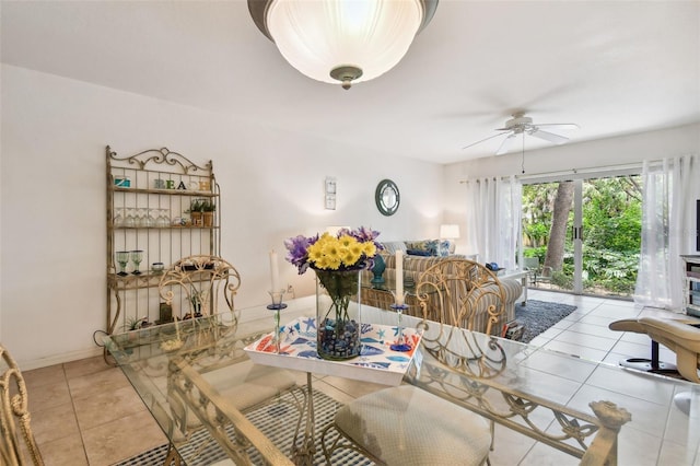 dining space with ceiling fan and light tile patterned flooring