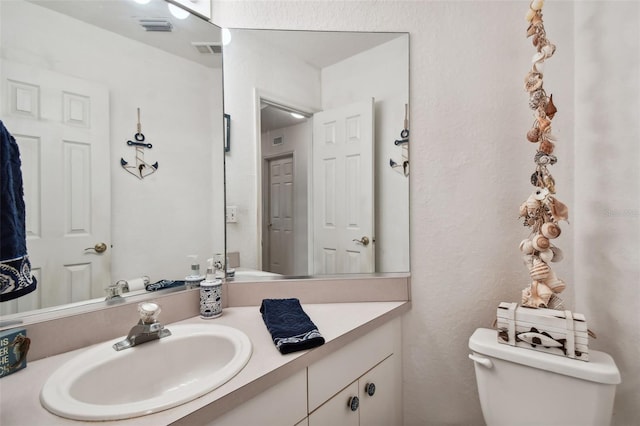 bathroom with vanity and toilet