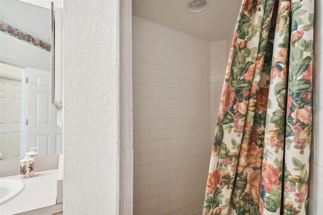 bathroom with vanity and walk in shower