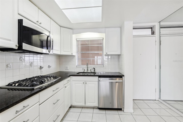 kitchen featuring light tile patterned flooring, sink, white cabinets, and stainless steel appliances