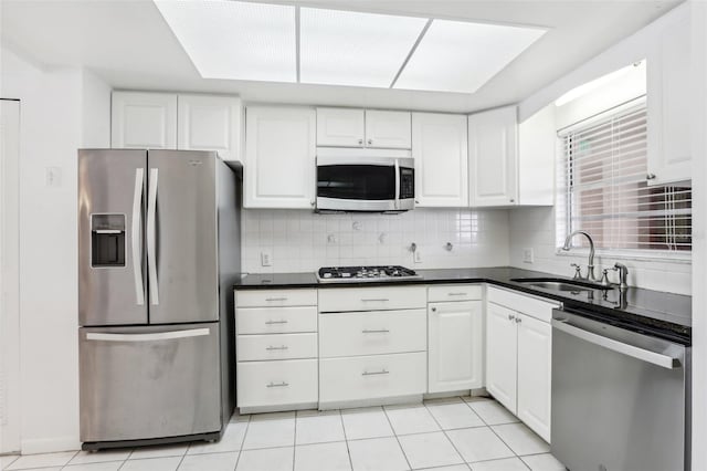 kitchen featuring white cabinets, sink, appliances with stainless steel finishes, and tasteful backsplash