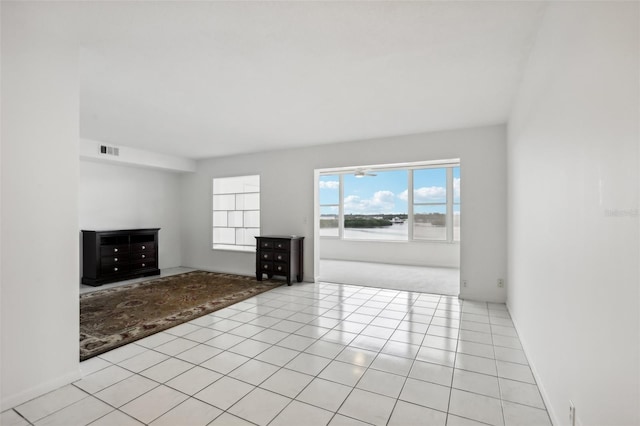 unfurnished living room with light tile patterned flooring